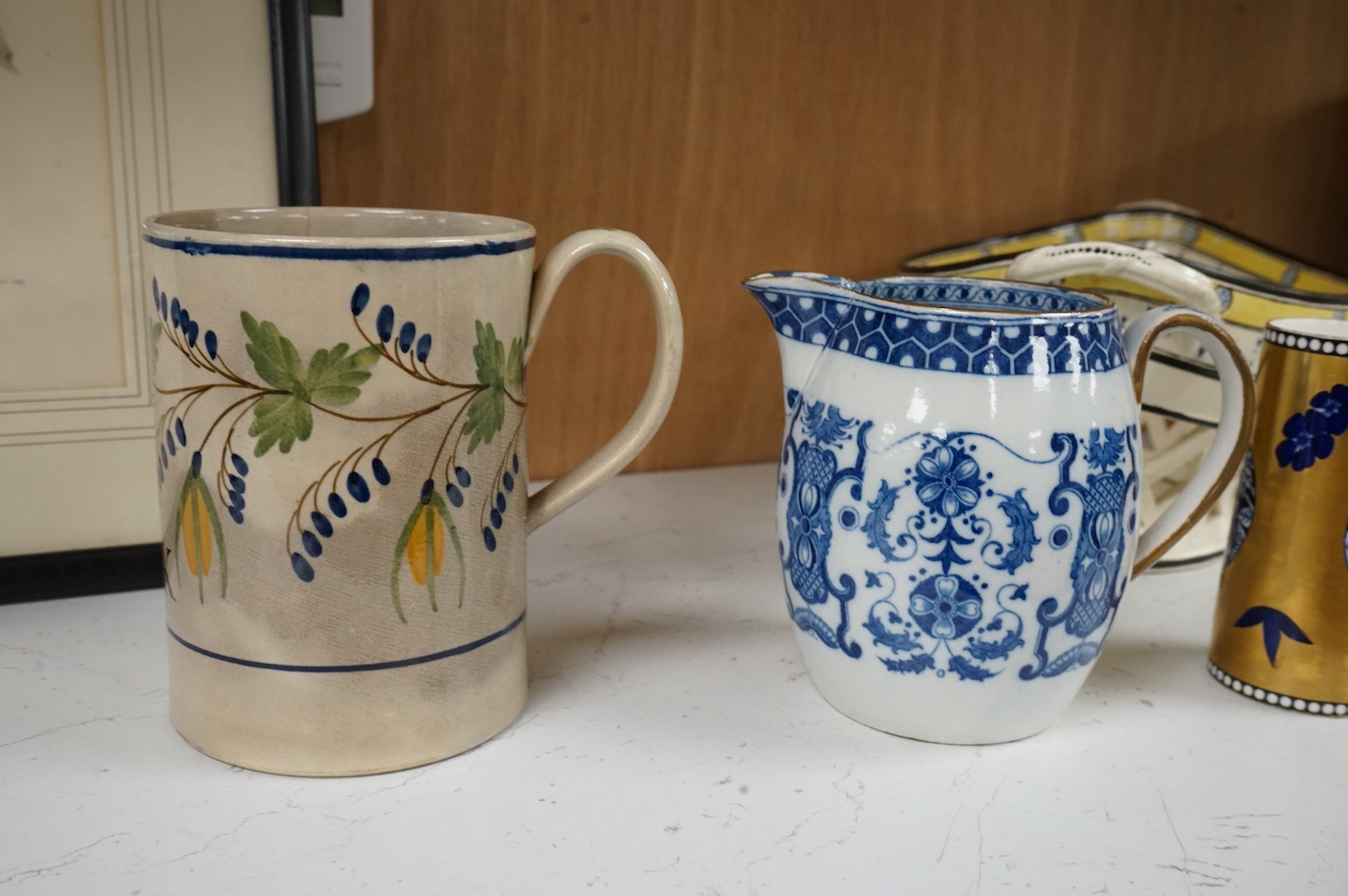 A George III creamware basket, a pearlware mug and jug, a Coalport spill vase (four), basket 26.5cm handle to handle.